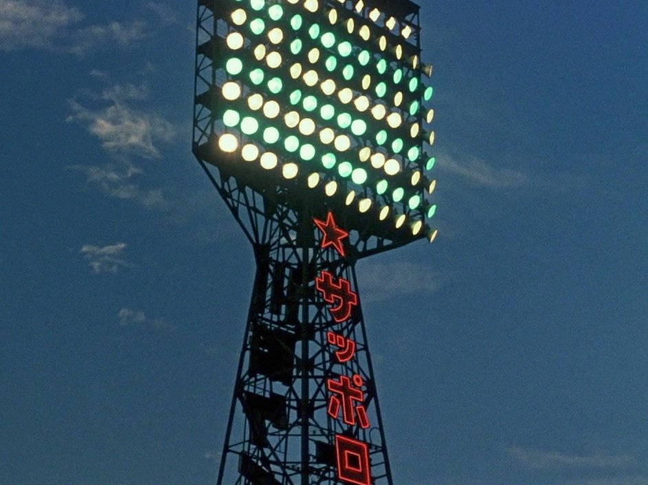 A striking shot of baseball stadium floodlights, nicely undercut moments later when its ageing male characters are shown to be watching the game on television