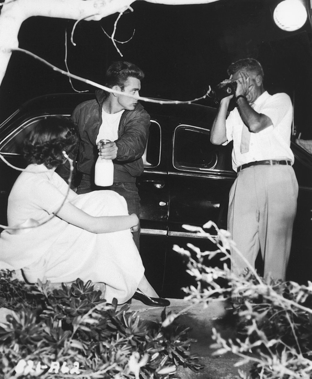 Milking the moment: director Nicholas Ray checks his viewfinder before filming a turbulent moment between James Dean and Natalie Wood